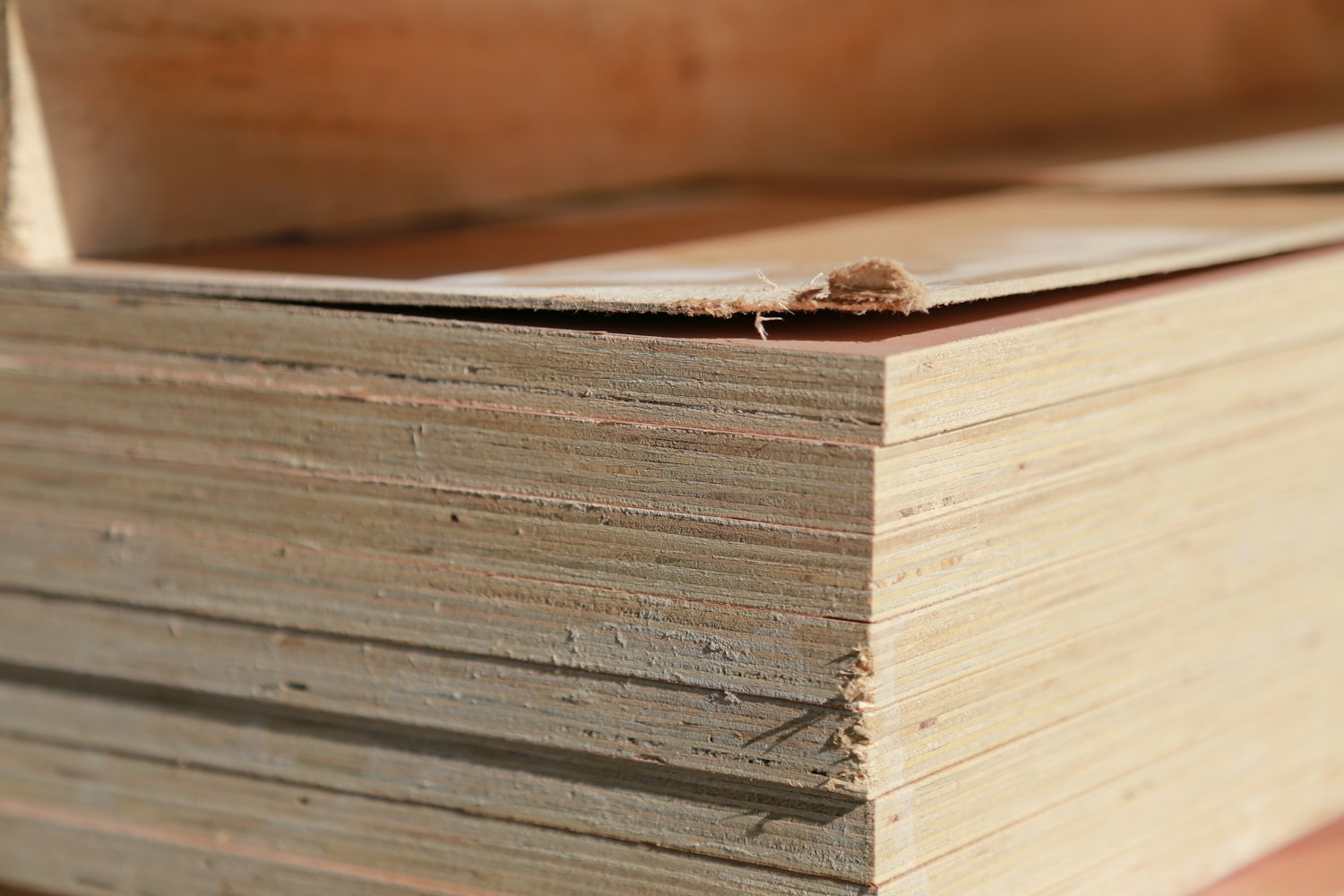 Stack of Vietnam plywood sheets with the ply layers visible along the edge